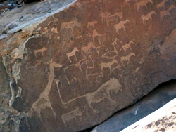 Rock painting showing lion with long tail ending in own footprint, Twyfelfontein